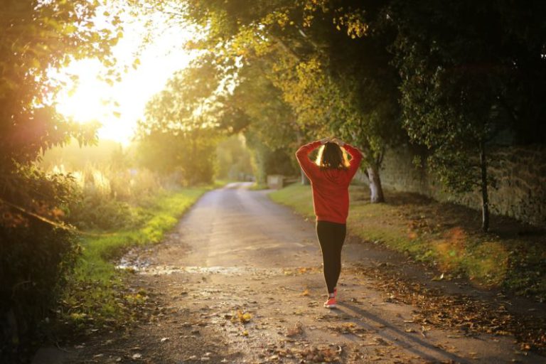 Wellness - woman walking on pathway during daytime