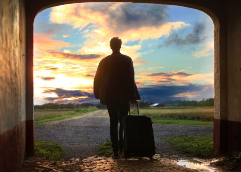 Traveler - man holding luggage photo