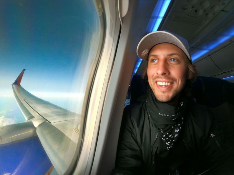 Traveler - smiling woman in black jacket wearing blue cap