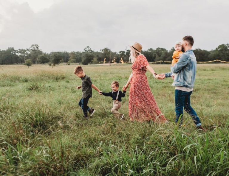 Family Fun - woman holding man and toddler hands during daytime