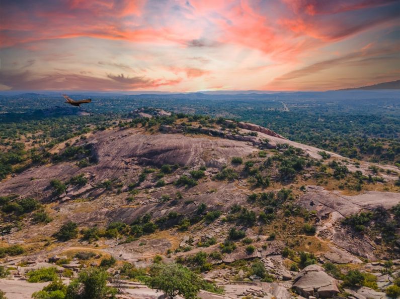 Texas - a plane is flying over a rocky mountain