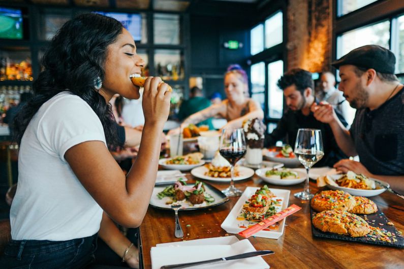 Restaurant - woman in white shirt eating