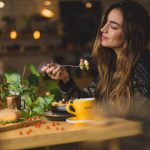 Restaurant - woman holding fork in front table