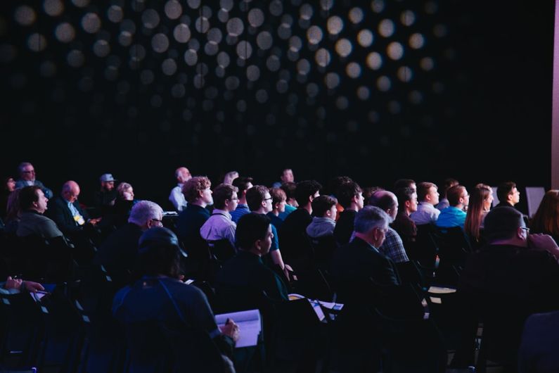 Event - crowd of people sitting on chairs inside room