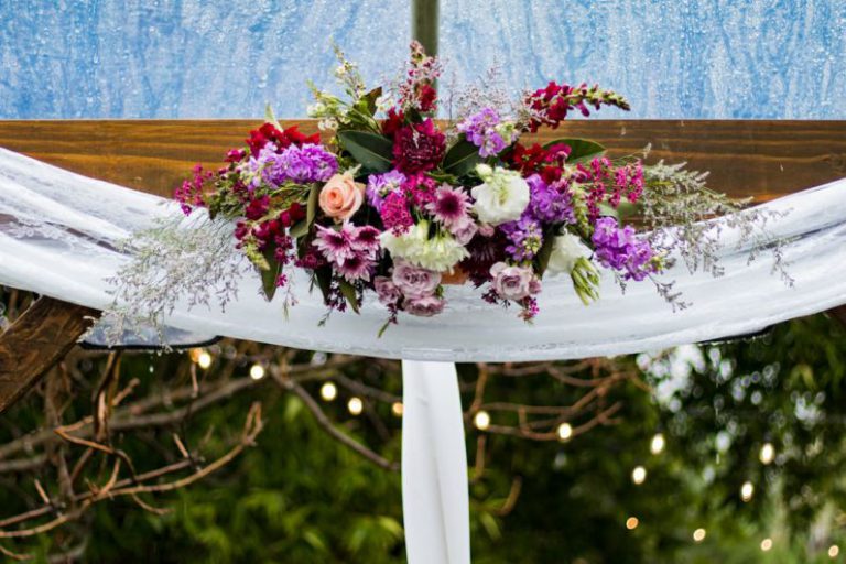 Ranch Wedding - white, pink, and red petaled flowers decor