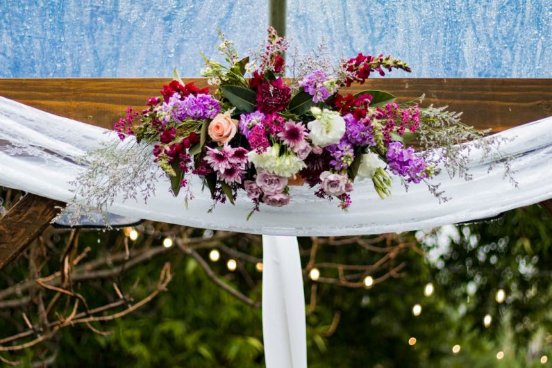 Ranch Wedding - white, pink, and red petaled flowers decor