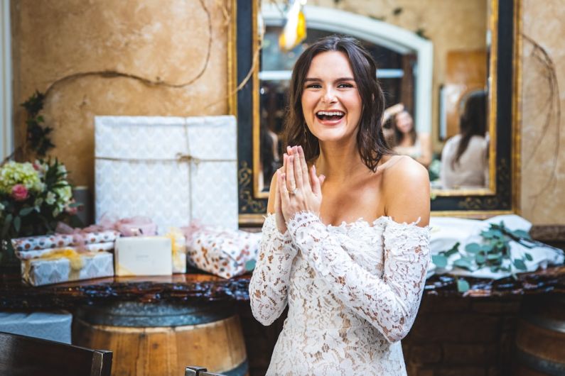 Ranch Wedding - woman in white floral off shoulder dress smiling