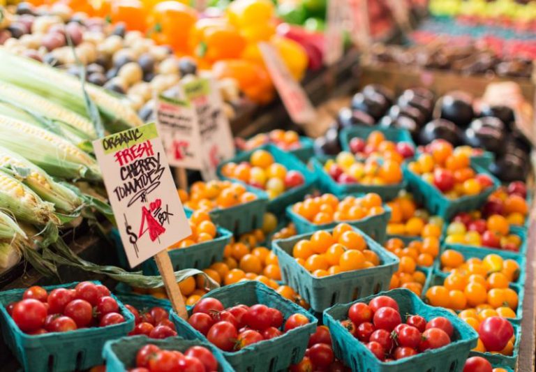 Farmers Market - red tomato lot on blue baskets