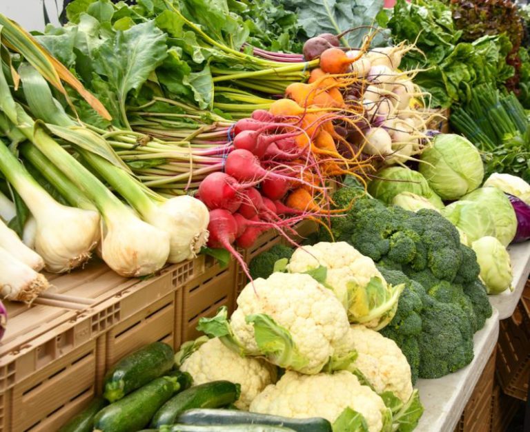 Farmers Market - green and red vegetable on brown wooden table