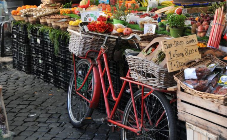 Farmers Market - red city bike with basket of fruits