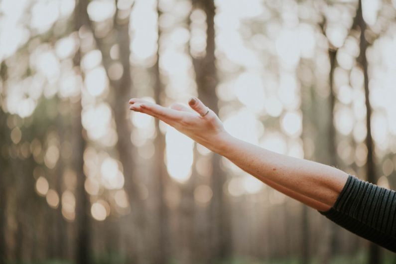 Wellness - tilt shift lens photography of person lifting hand